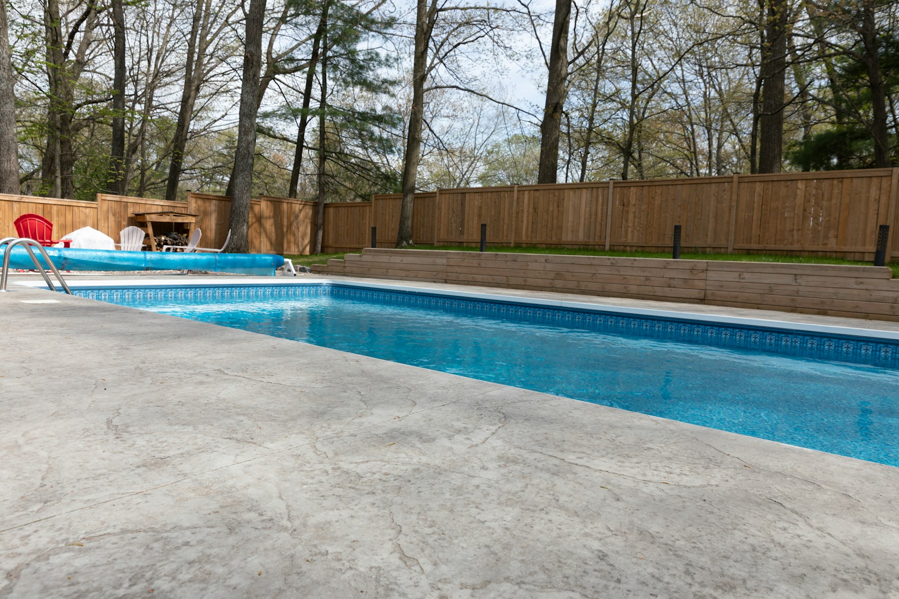Clean residential backyard pool with clear blue water